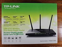 Front of retail box showing TP-Link Archer C1200 router image and key specifications