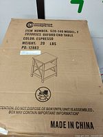 Sealed box showing brand, item number, model, color, weight and line drawing of the end table