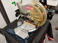 Right side view showing blade guard, motor housing, and base