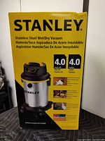 Front of boxed Stanley stainless wet/dry vacuum showing capacity and horsepower