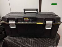 Front view of closed Stanley FatMax toolbox showing brand badge, latches and handle