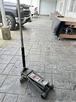 Full view of floor jack with handle upright