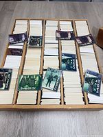 Open 5,000-count card box nearly full with stacks of Doctor Who trading cards, several foil cards displayed on top