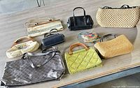 All nine handbags laid out on table