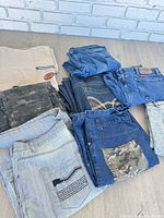 All eight denim pieces folded on floor