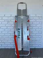 Full view of assembled aluminum scoop stretcher with straps attached