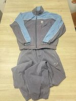 Full view of jacket and pants laid flat