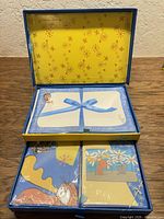Open gift box showing three stationery sets