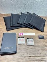 Overview of all Mary Kay items: five pouches, boxed compact, two blush refills, boxed eyeliner-sized product, sample card