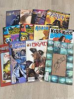 Group shot of all 12 comics spread on floor