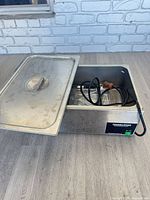 Warmer with lid partially open showing interior