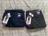 Both folded pants with size and brand tags visible