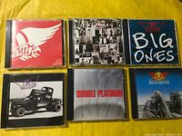 Six CD jewel cases displayed front covers visible