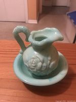 Pitcher resting in basin showing overall form and color