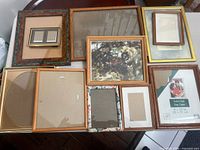 Overview of nine assorted picture frames laid out on table