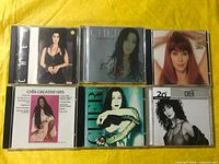 Front view of all six Cher CDs