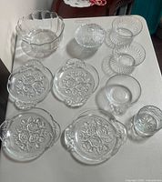 all eleven clear glass pieces laid out on table