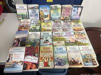 All 24 Debbie Macomber paperbacks laid out in four rows