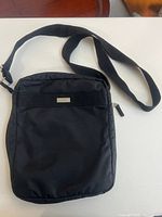 Front view showing DKNY plaque, strap, overall shape