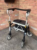 Front angle of rollator showing frame, wheels, seat and basket