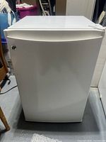 Front exterior view of GE white compact mini fridge