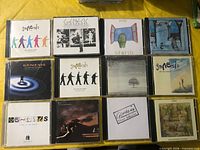 Overview of 12 Genesis CDs in three rows