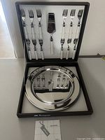 Full set in open presentation box showing platter and utensils