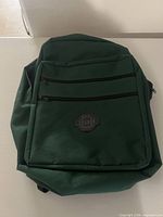 Front view showing colour, logo patch, and zip pockets