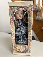 Front view of boxed porcelain doll