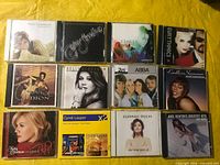 All 12 CDs arranged on yellow background