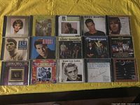 All 15 jewel-case CDs laid out on table