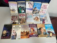 Group shot showing all 16 paperback books laid out in three rows