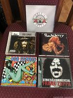 All five CD jewel cases front covers visible