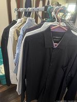 Row of assorted dress shirts on hangers