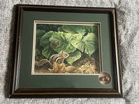 Full view of framed chipmunk print with green mat and wood-look frame