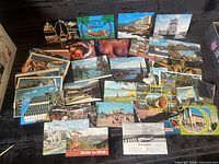 Spread of assorted international postcards laid out
