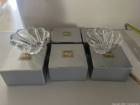 Three Mikasa boxes with two crystal bowls displayed on top