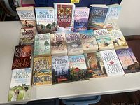 Entire lot laid out showing all 21 Nora Roberts books