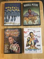 Front covers of four Russell Peters DVDs