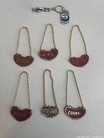 Overview of all six liquor tags and keychain