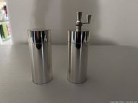 Front view of salt shaker and pepper mill showing overall form and finish