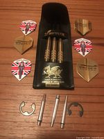 Open case with three darts, six flights and accessories visible