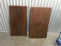 Front view of both teak shelf boards standing upright