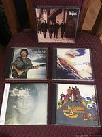 Front covers of all five CD cases on chair