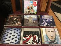 Seven CD jewel cases displayed on chair