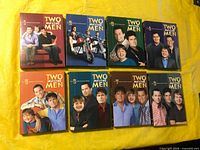 Front view of all eight season box sets laid out