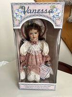 Front view of boxed Vanessa Ricardi porcelain doll