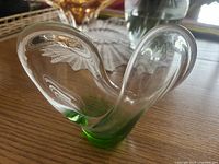 Overall view of clear and green freeform sculpture on table