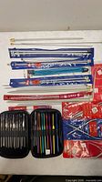 Overall lot showing straight needles in retail sleeves, circular needles and zip case