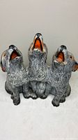 Front view of three-wolf sculpture